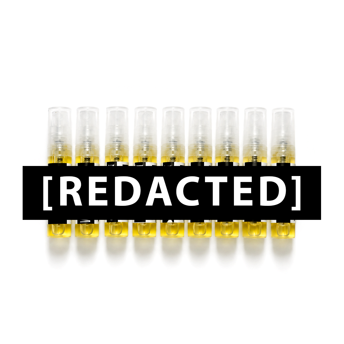 Row of small BYZA perfume samples with a redacted label on a white background