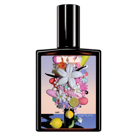 A perfume bottle with a glossy black glass body and a tall cylindrical cap, featuring a colorful floral and fruit-themed label. The label includes a large white flower, pink and purple blossoms, lemons, limes, macarons, and the text 'DIZZY' and 'parfum'.
