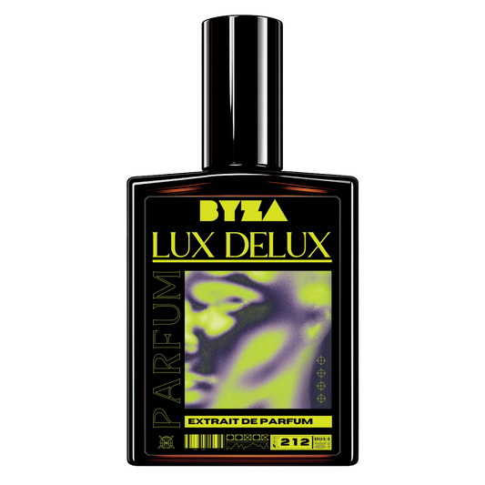 A bottle of Byza Lux Delux Extrait de Parfum, featuring a black rectangular glass bottle with a matching black cap. The label is primarily black with bold yellow text and a central graphic showing a green and purple abstract face.
