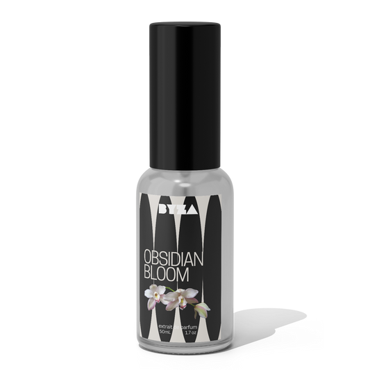 A bottle of Obsidian Bloom perfume with a black cap and a label featuring an image of a white flower.
